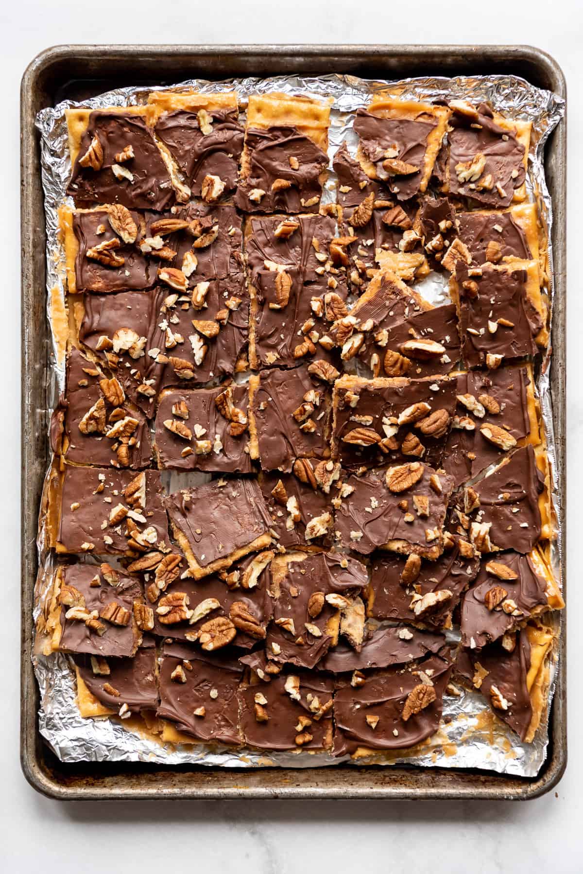 A baking sheet filled with a batch of Christmas crack.