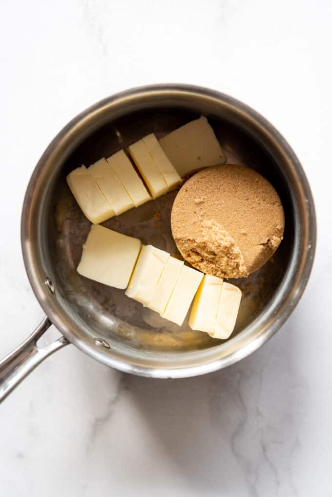 Cubed butter and brown sugar in a saucepan.
