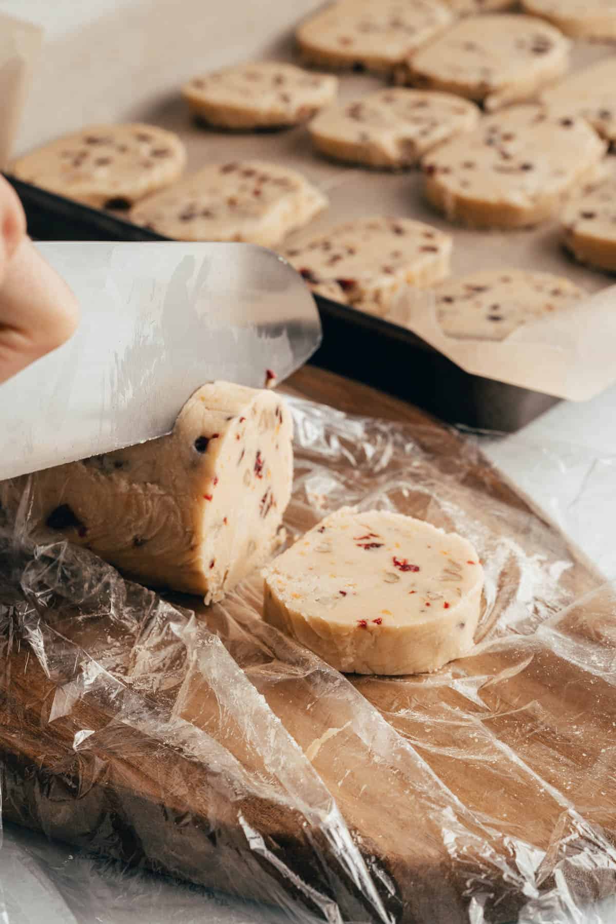 Slicing shortbread slice and bake cookies on a cutting board.