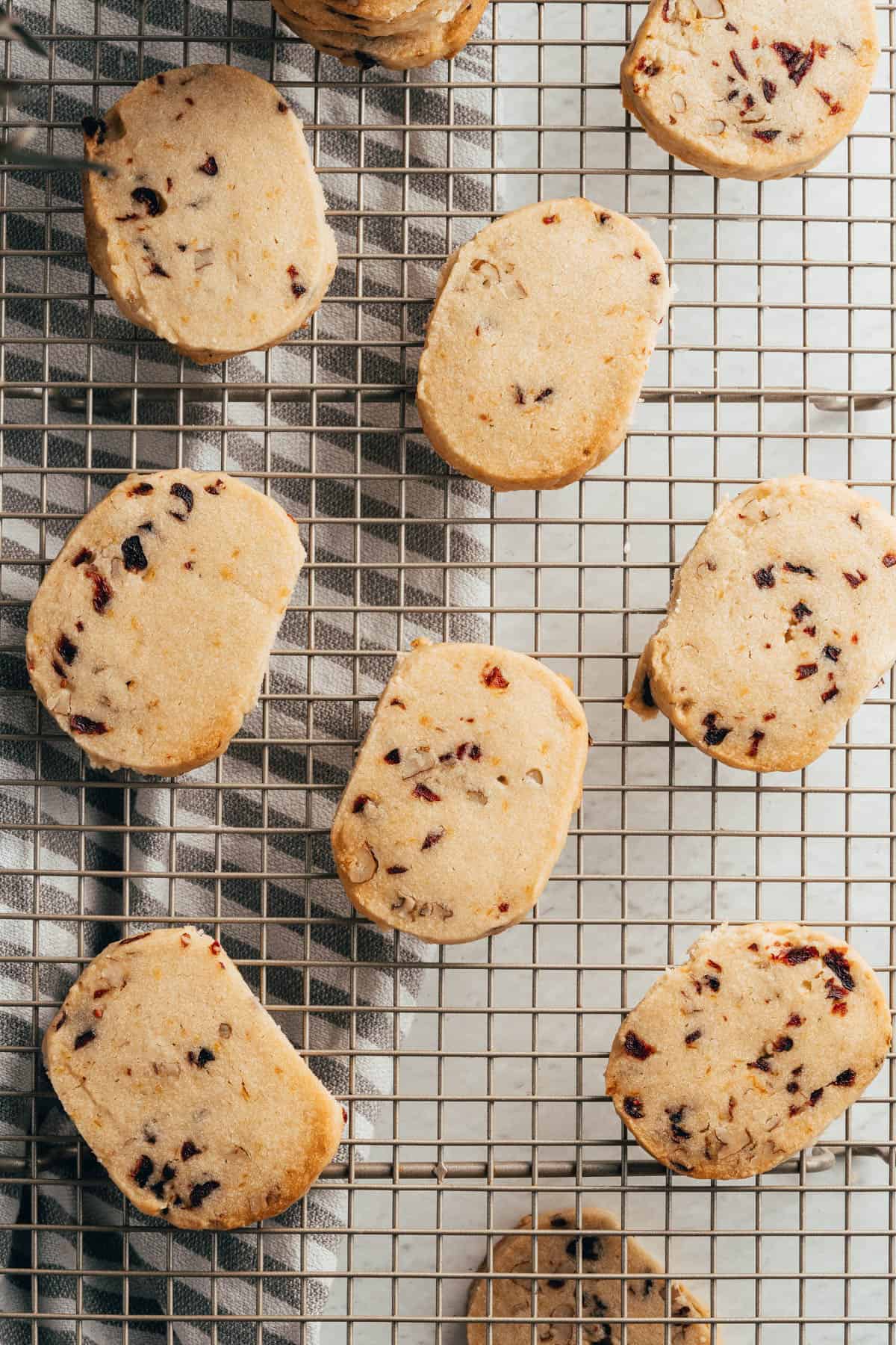 An overhead image of a cranberry pecan shortbread on a wire rack.
