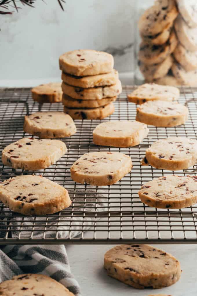 Cranberry pecan shortbread cookies on a wire cooling rack.