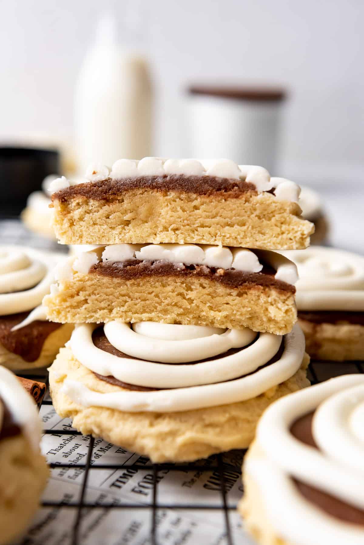 Two halves of copycat Crumbl cinnamon roll cookies stacked on top of each other.