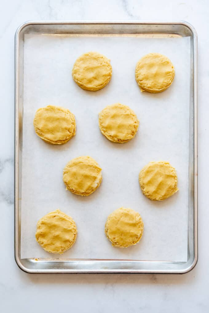 Unbaked cookies on a baking sheet lined with parchment paper.