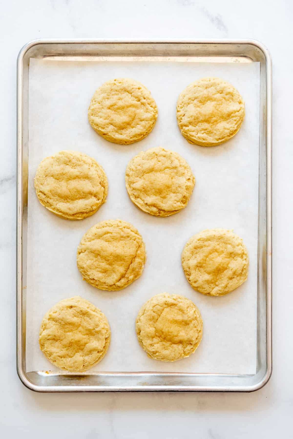Baked cookies on a baking sheet lined with parchment paper.