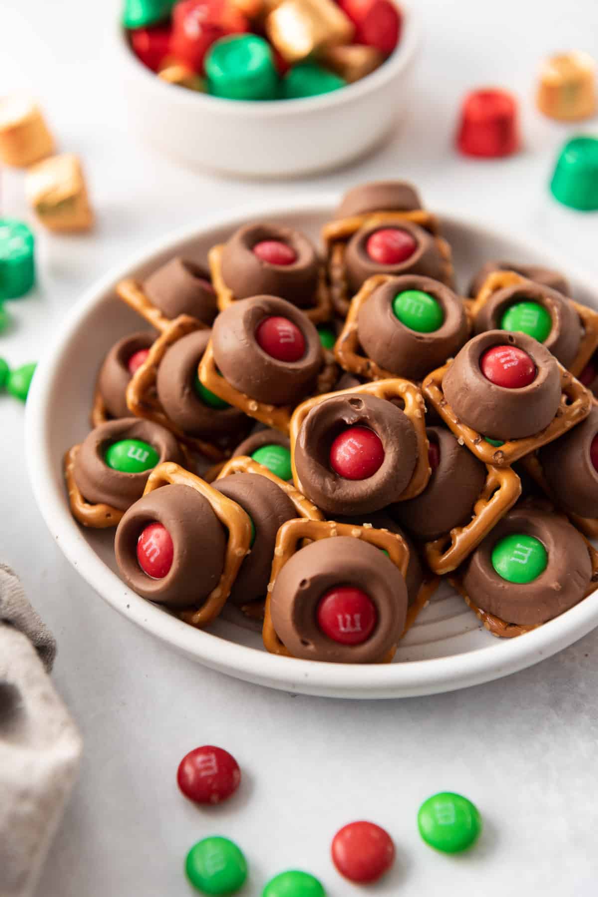 A plateful of Rolo pretzels with red and green Christmas M&Ms.