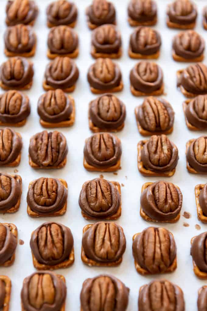 Whole pecans that have been pressed into warm, softened Rolos on pretzels to make easy Christmas candy.