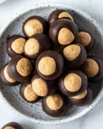 A plate of homemade peanut butter chocolate buckeyes balls.