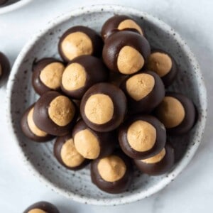 A plate of homemade peanut butter chocolate buckeyes balls.
