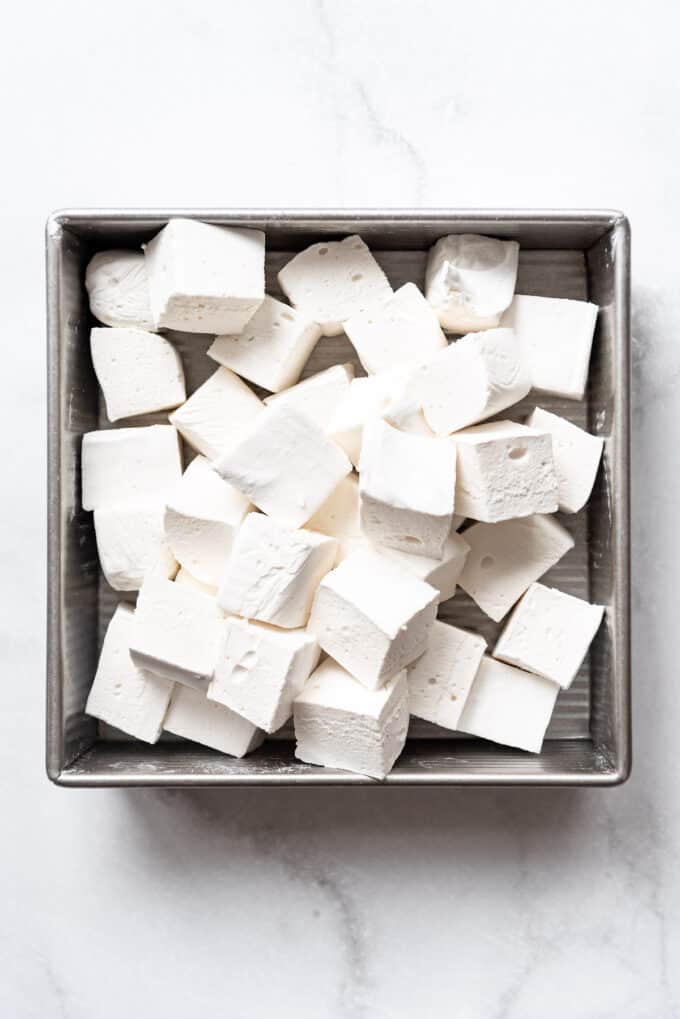 A square baking dish holding freshly made homemade marshmallows.