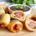 Jalapeno popper pigs in a blanket stacked in a pile.