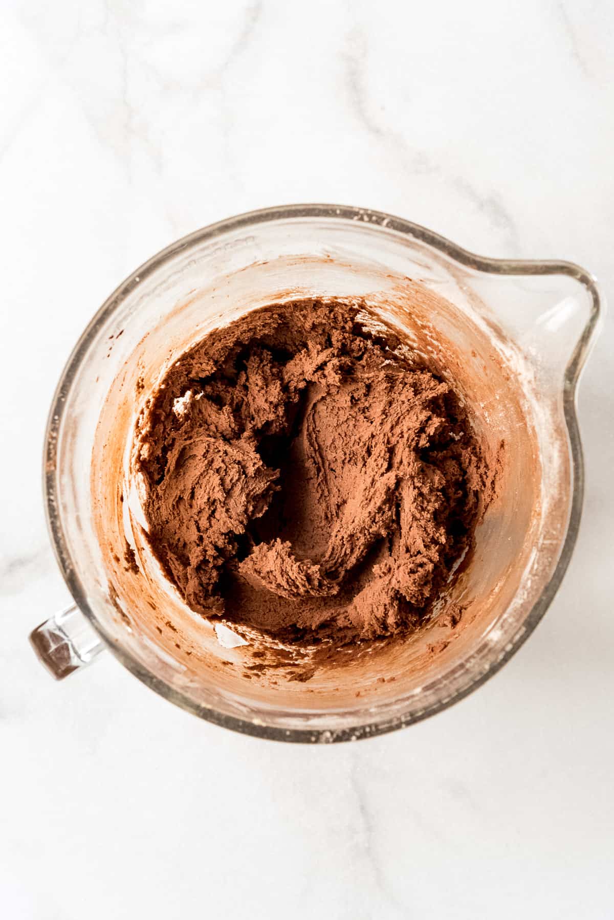 Chocolate cookie dough in a glass bowl.