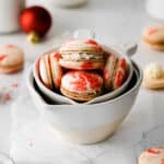 Peppermint macarons in white measuring cups.