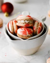 Peppermint macarons in white measuring cups.