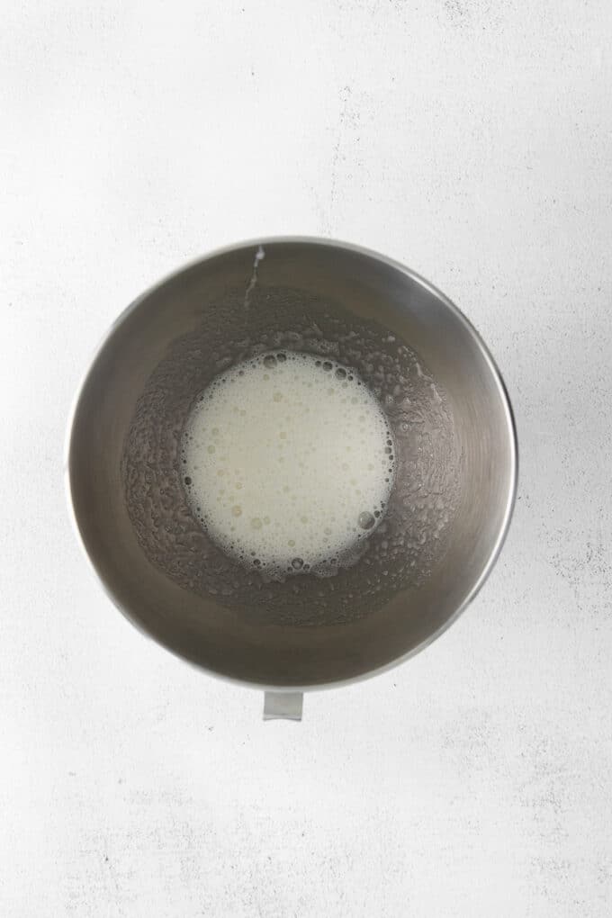 Lightly beaten egg whites in a mixing bowl.