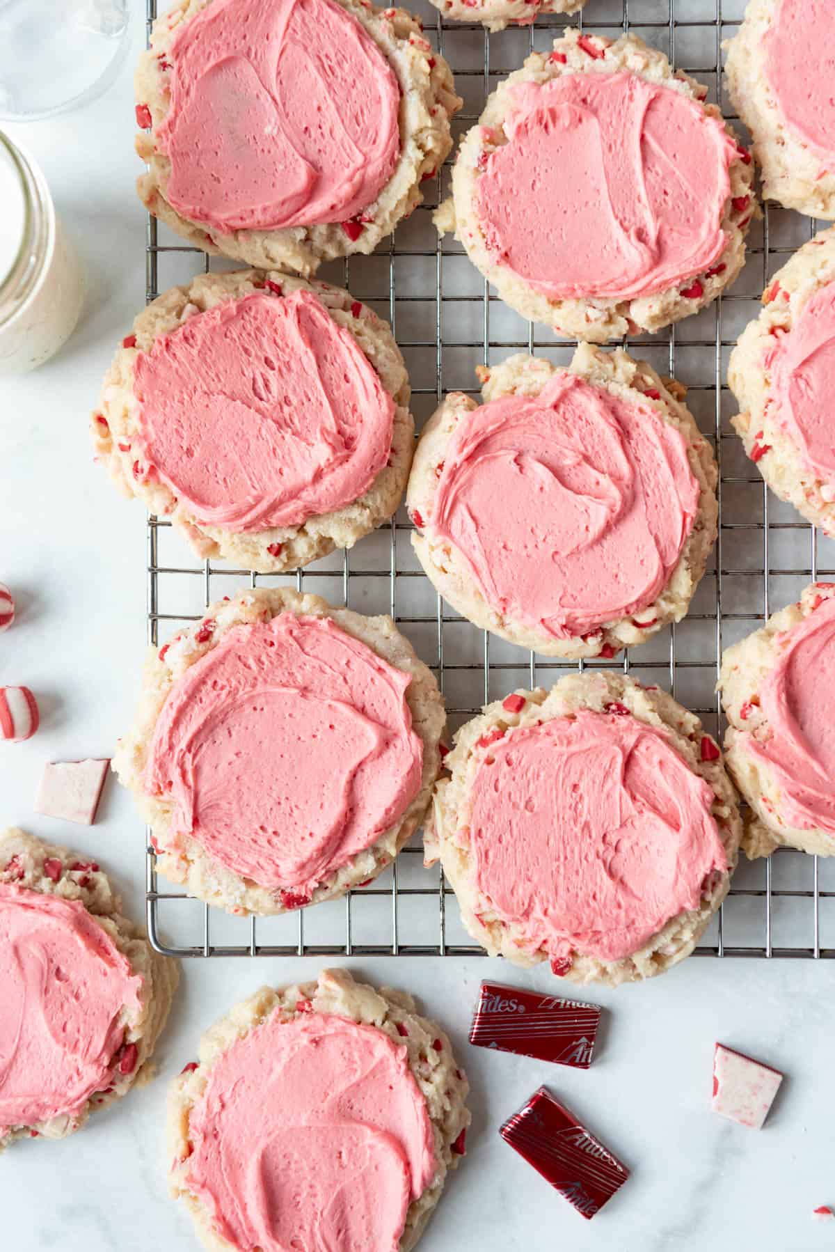 Soft frosted peppermint sugar cookies on a wire rack.