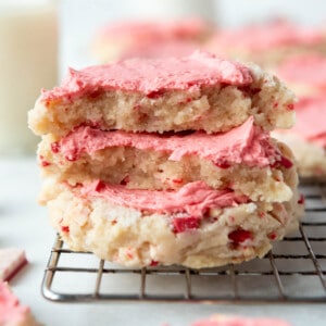 An image of peppermint swig sugar cookies stacked on top of each other.