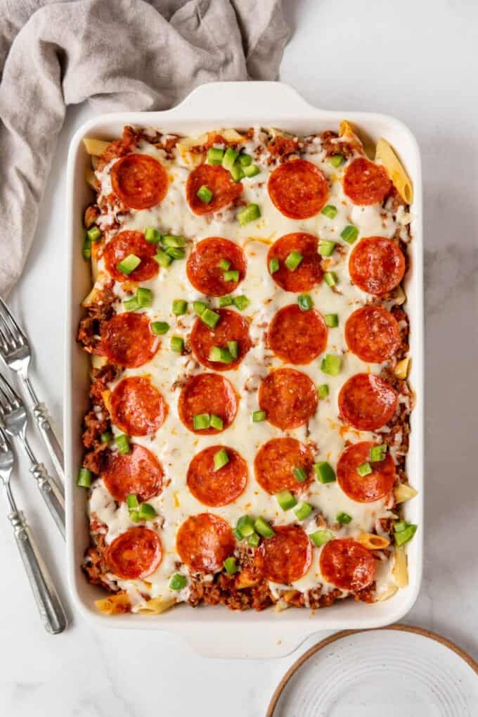 A baked pizza casserole in a white ceramic dish.
