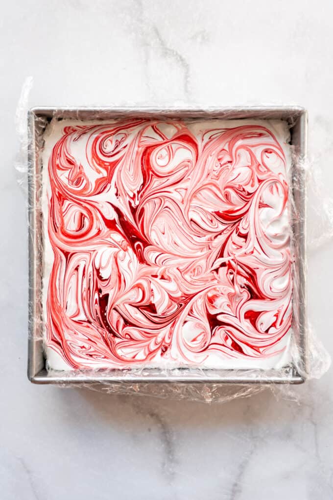 Swirling the red food coloring into homemade marshmallows.