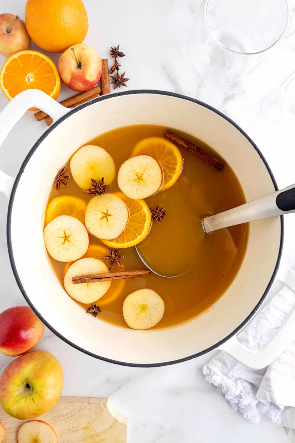 An overhead image of a pot of wassail with a ladle in it.