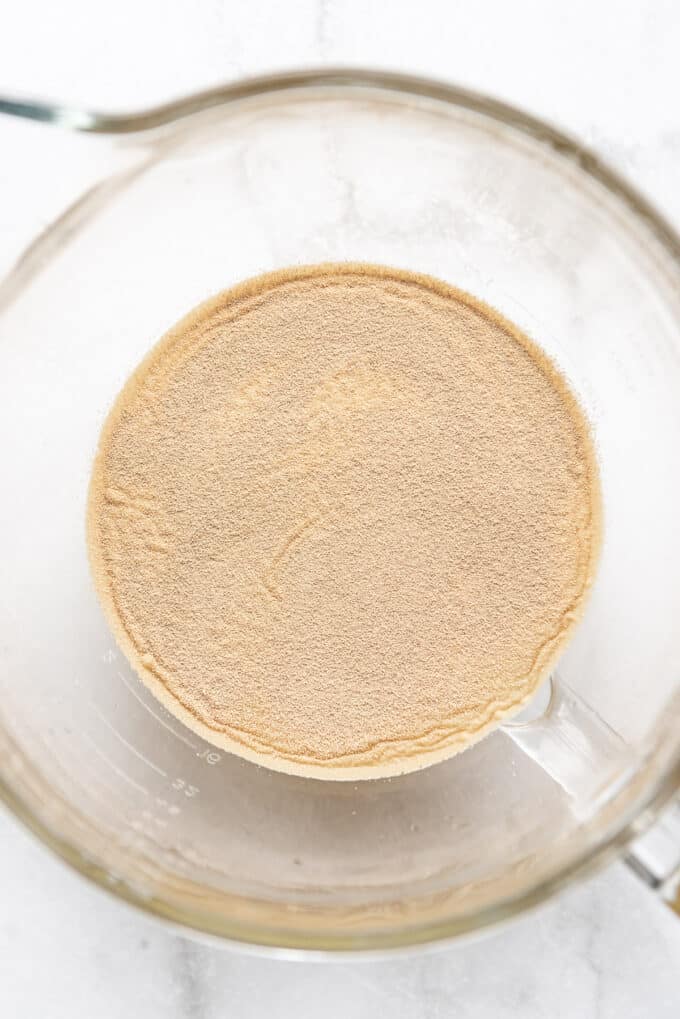 Active dry yeast in a bowl with warm water and sugar.