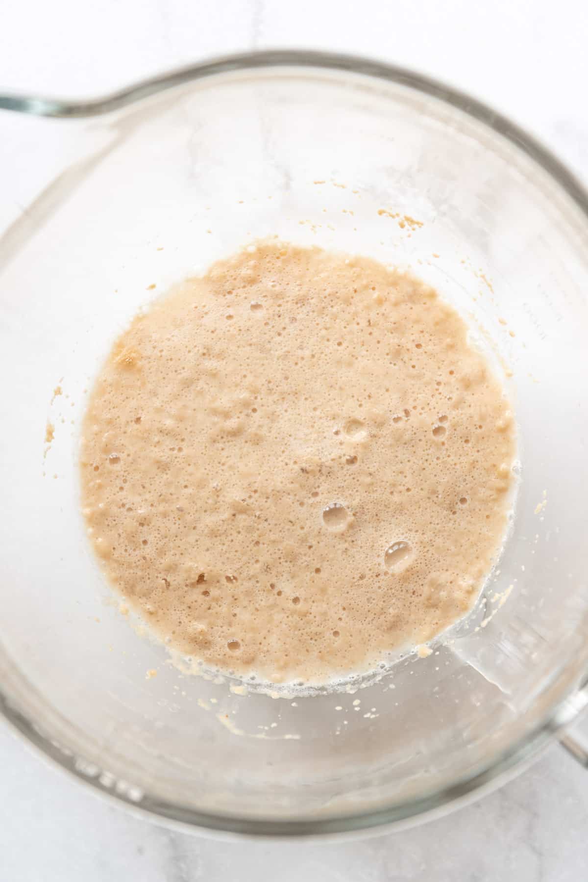 Foamy proofed active dry yeast in a glass bowl.