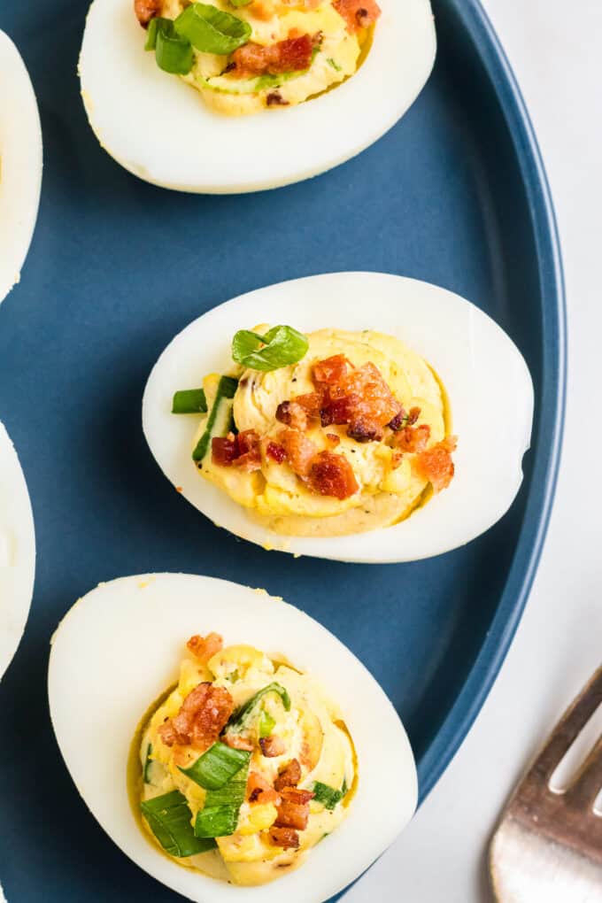 Deviled eggs on a blue plate.