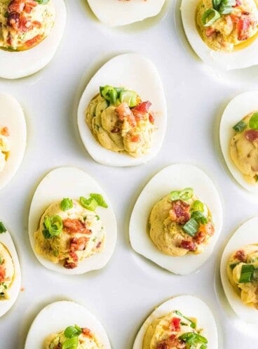 A white plate with deviled eggs on it.