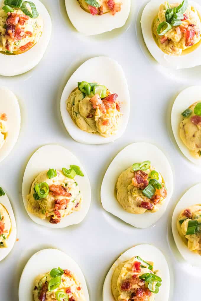 A white plate with deviled eggs on it.