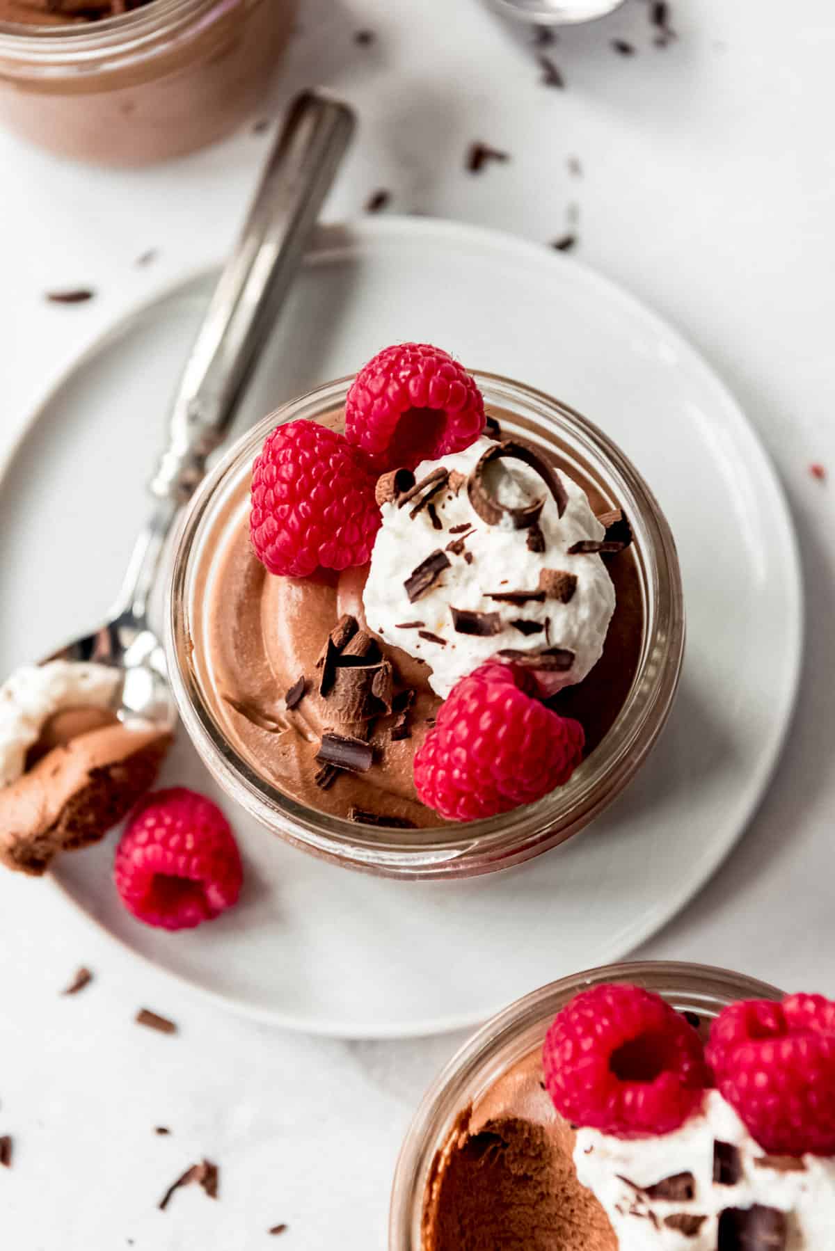 Chocolate Mousse garnished with raspberries and whipped cream.