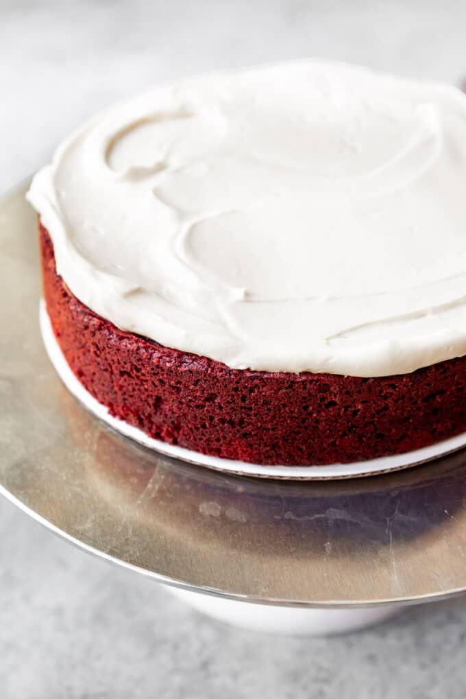 An image of a single layer of red velvet cake that has been frosted with cream cheese frosting.