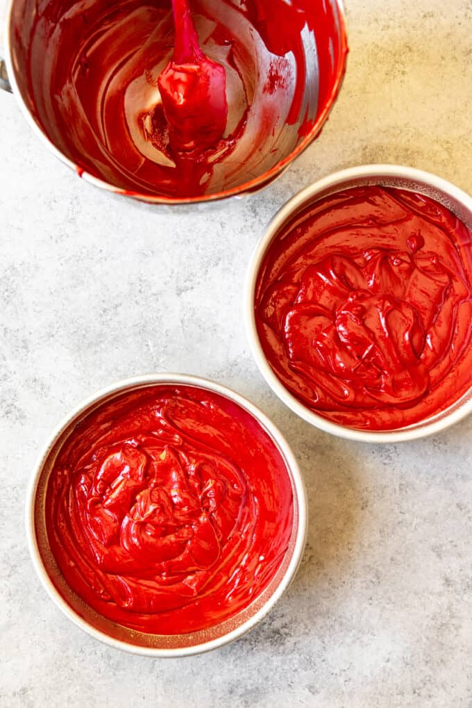 An image of two 8-inch cake pans filled with red velvet cake batter and ready to go into the oven.