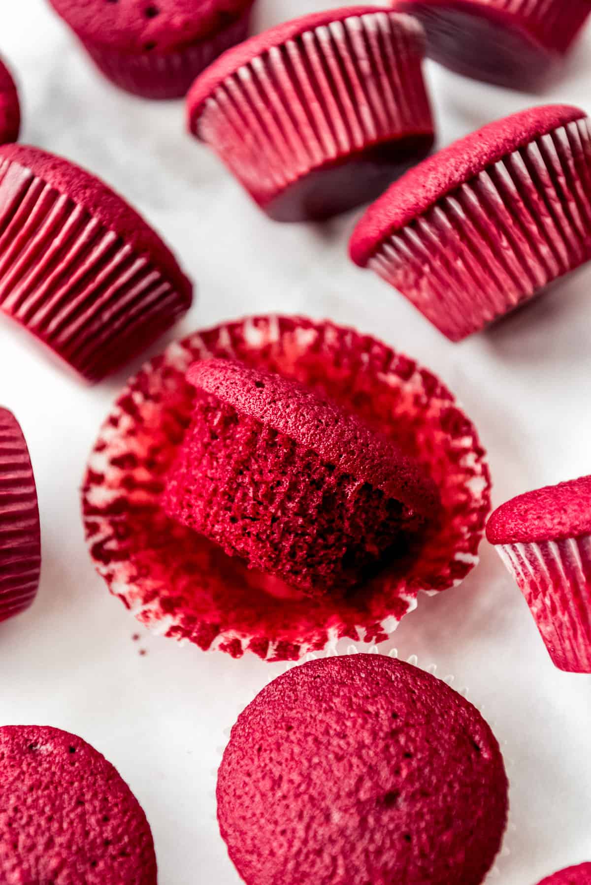 An unwrapped, unfrosted red velvet cupcake.