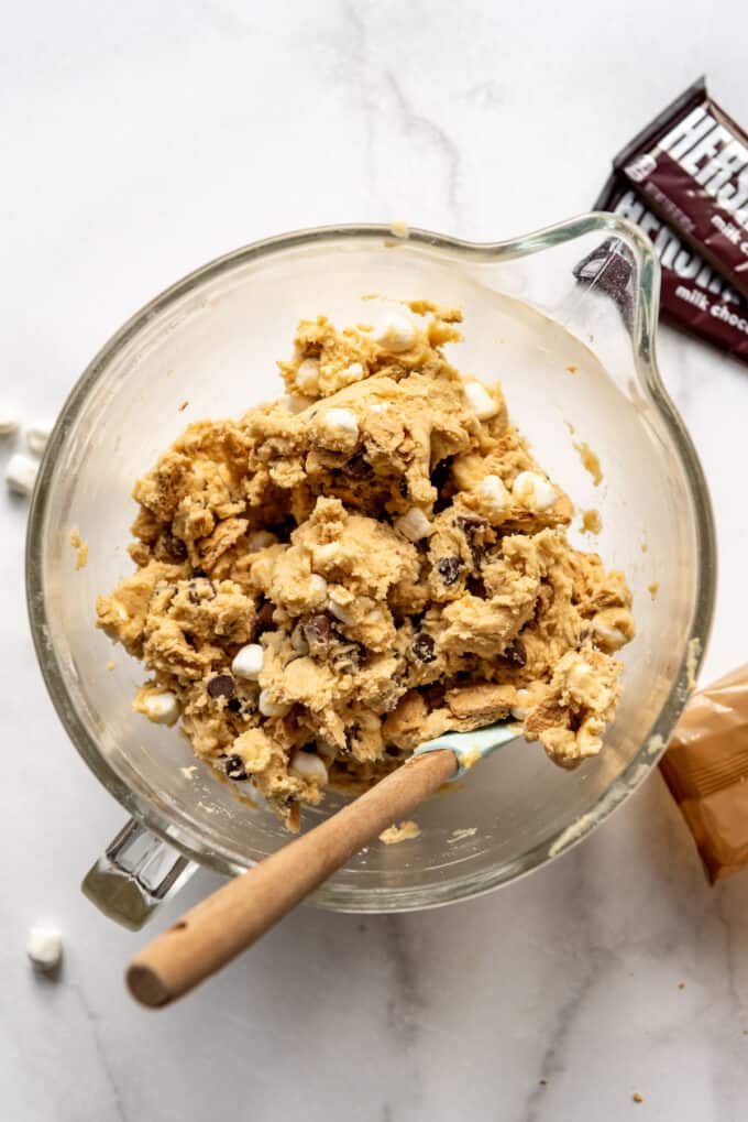 S'mores cookie dough in a glass bowl with a spatula.