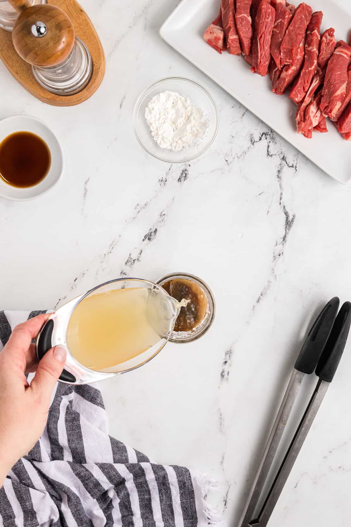 Adding chicken broth to a simple brown sauce.