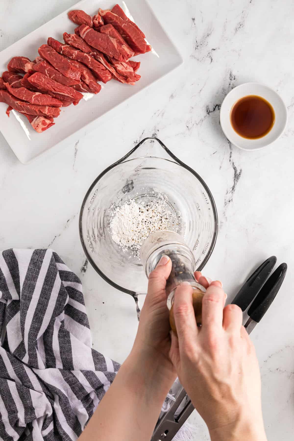 Seasoning cornstarch in a glass bowl.