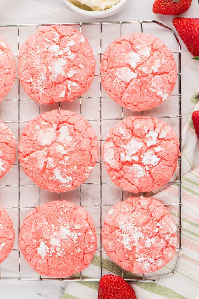 Strawberry cake mix cookies with powdered sugar on the outside.