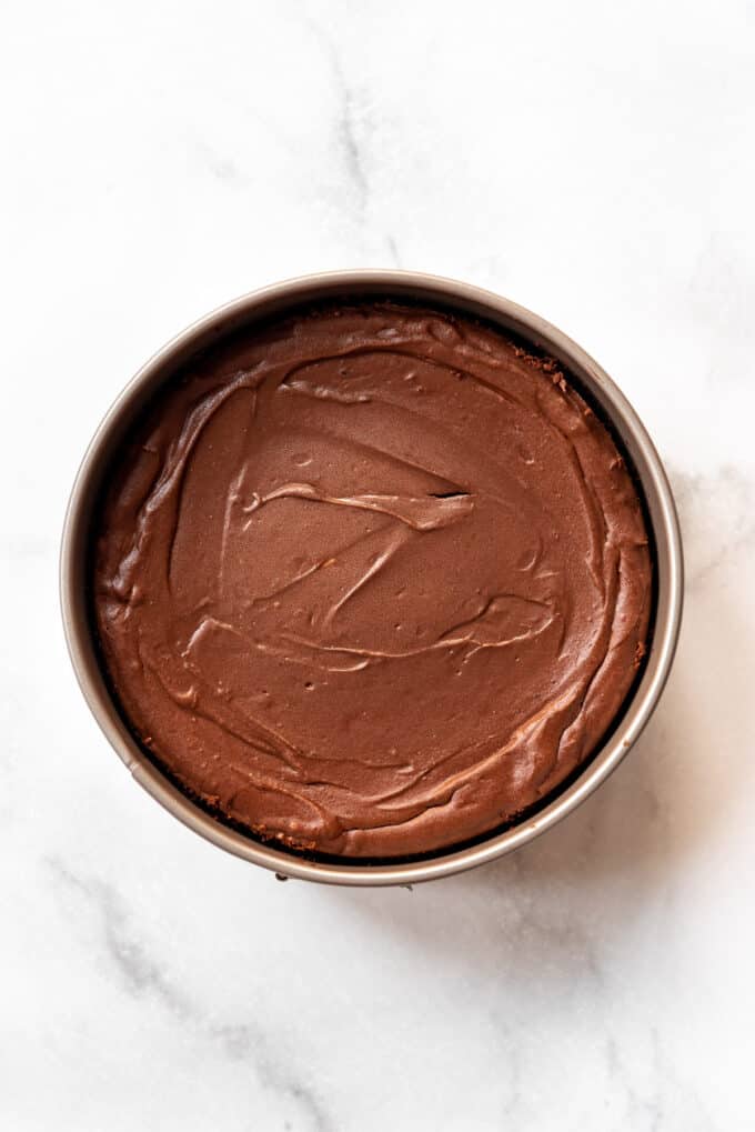 A baked chocolate cheesecake in a springform pan.