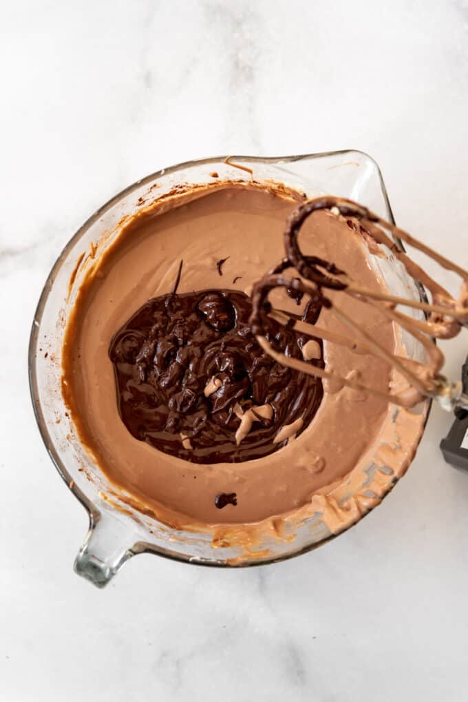 Adding melted chocolate to cheesecake batter.