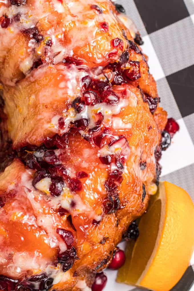 A close image of a simple glaze on cranberry orange monkey bread.