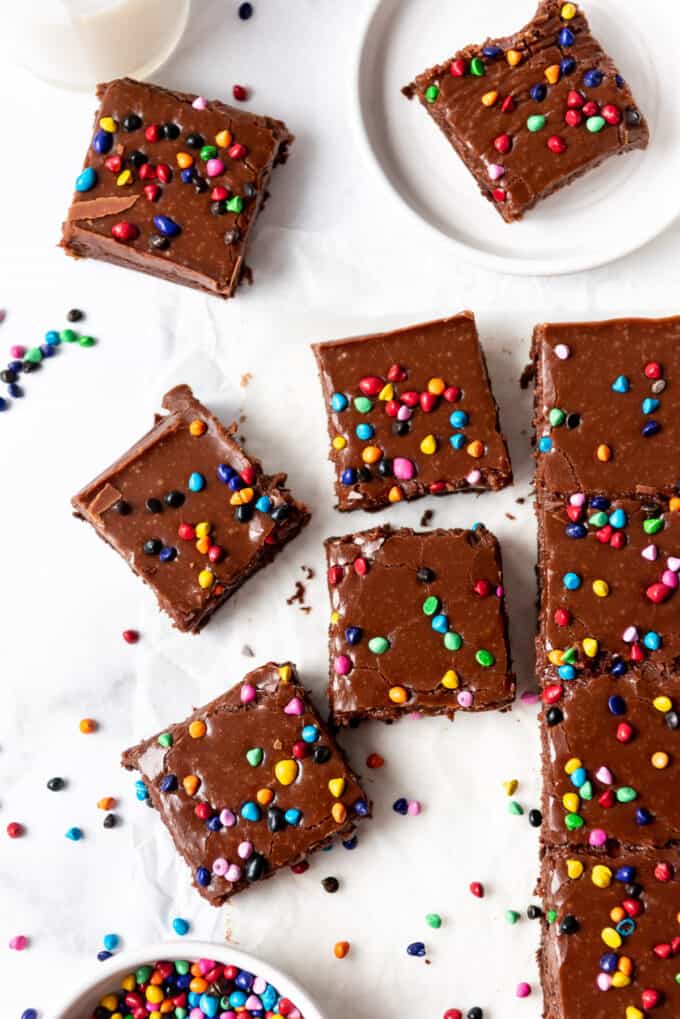 Homemade cosmic brownies squares on white parchment paper.