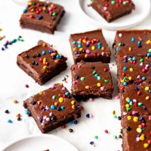 Homemade cosmic brownies squares on white parchment paper.