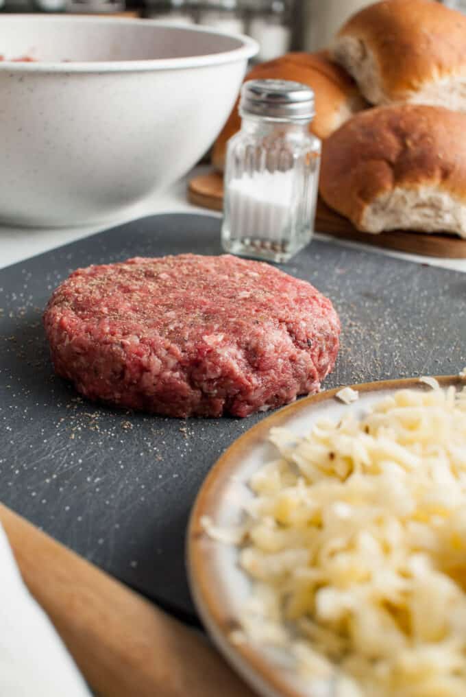 A juicy lucy hamburger patty stuffed with pepper jack cheese and seasoned with salt and pepper.