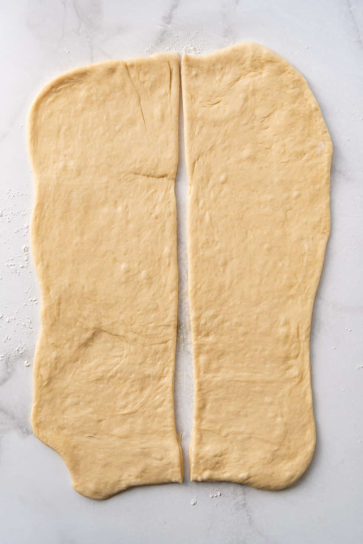 Rolled out rectangles of dough on a floured surface.