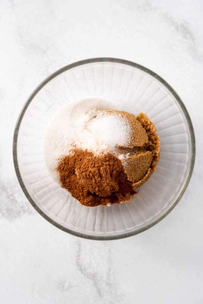 Cinnamon, sugar, and flour in a glass bowl.
