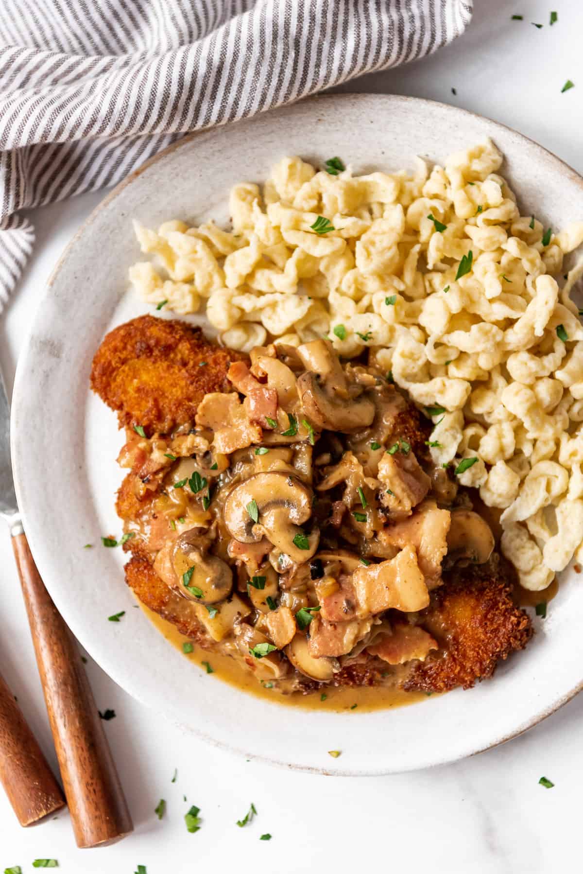 Jagerschnitzel with gravy and spaetzel served with parsley