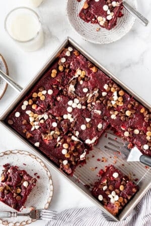 A red velvet earthquake cake in a rectangular baking dish sliced into squares.