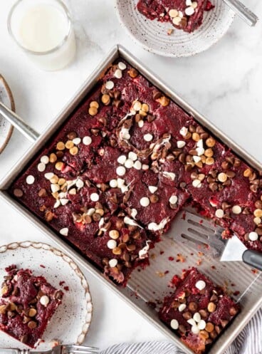 A red velvet earthquake cake in a rectangular baking dish sliced into squares.