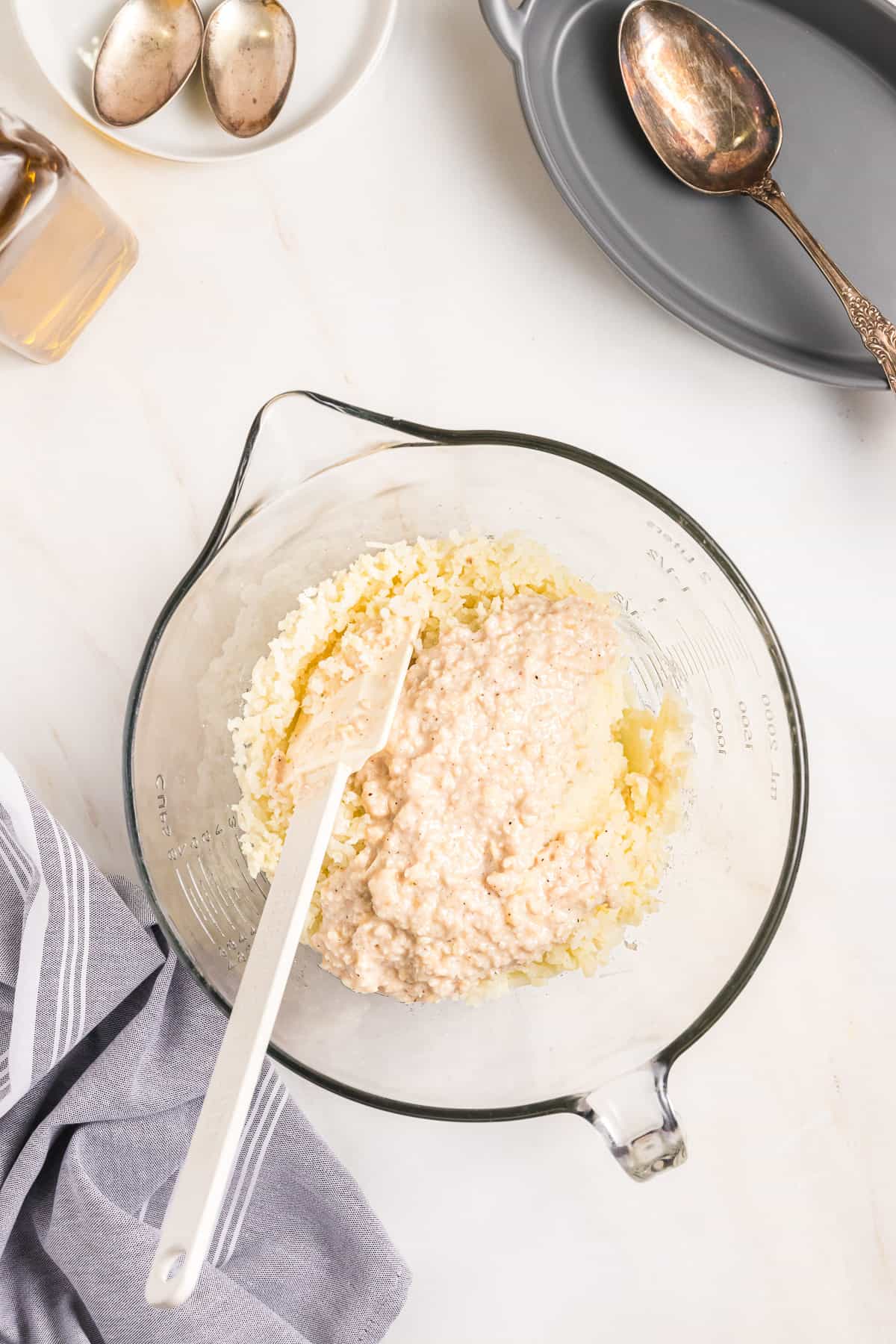 A bowl filled with mashed potatoes and garlic almond paste.