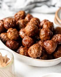 A serving bowl filled with easy grape jelly meatballs.