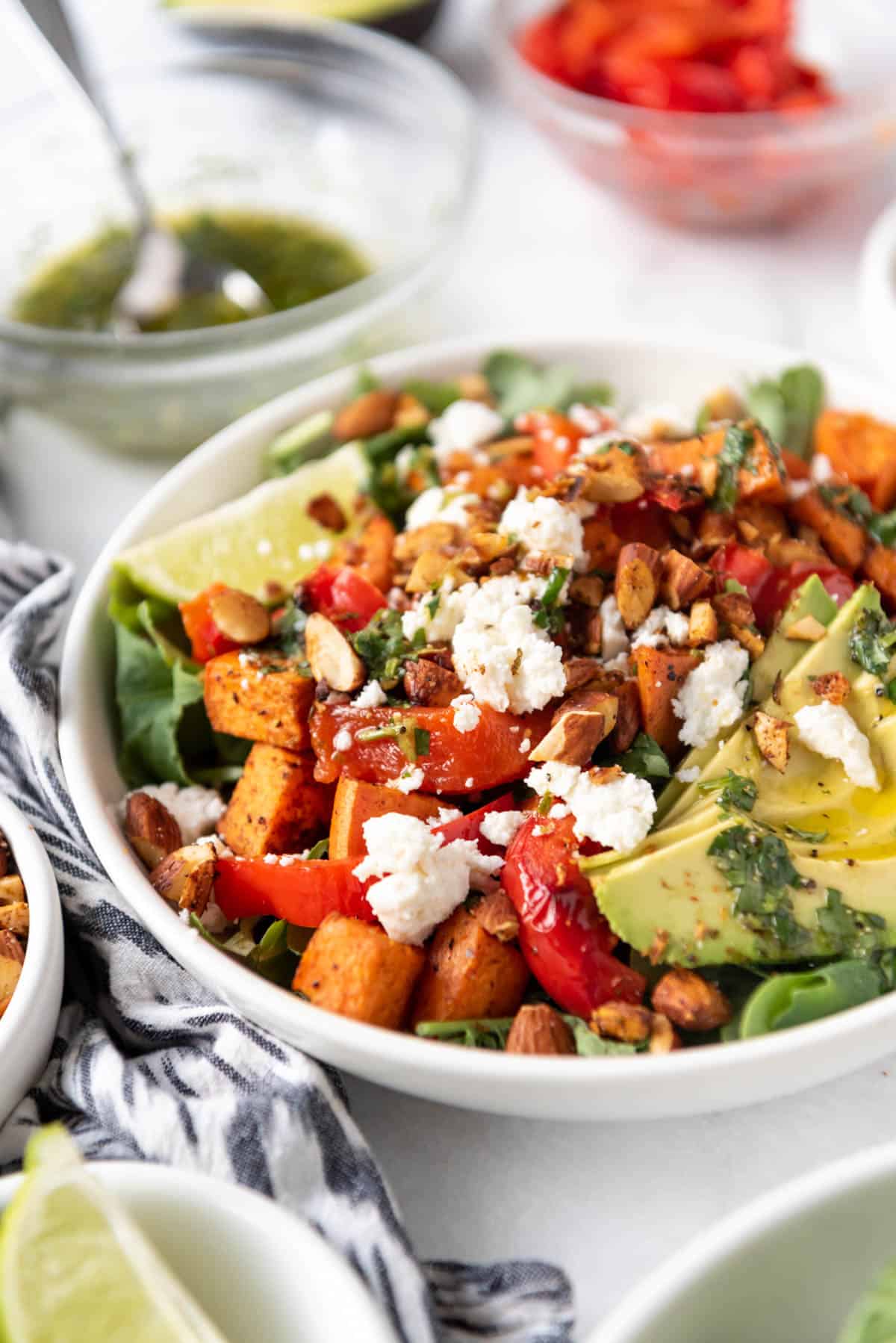 A buddha bowl with grains, greens, proteins, and queso fresco on top.